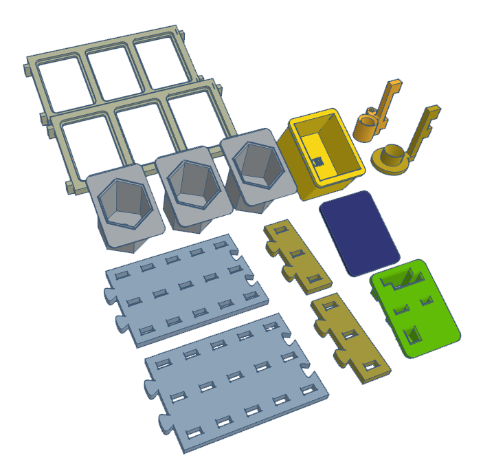 Various 3D printed components in different shapes and colors arranged on a flat surface.