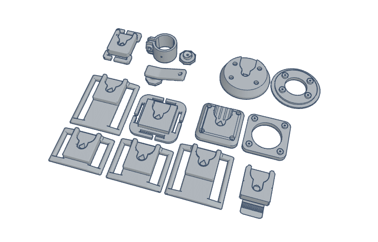 Various components of firearms accessories arranged in a flat layout, including mounts and attachments.