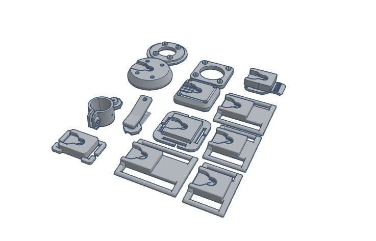 Various components of firearms accessories arranged in a flat layout, including clips and mounts.