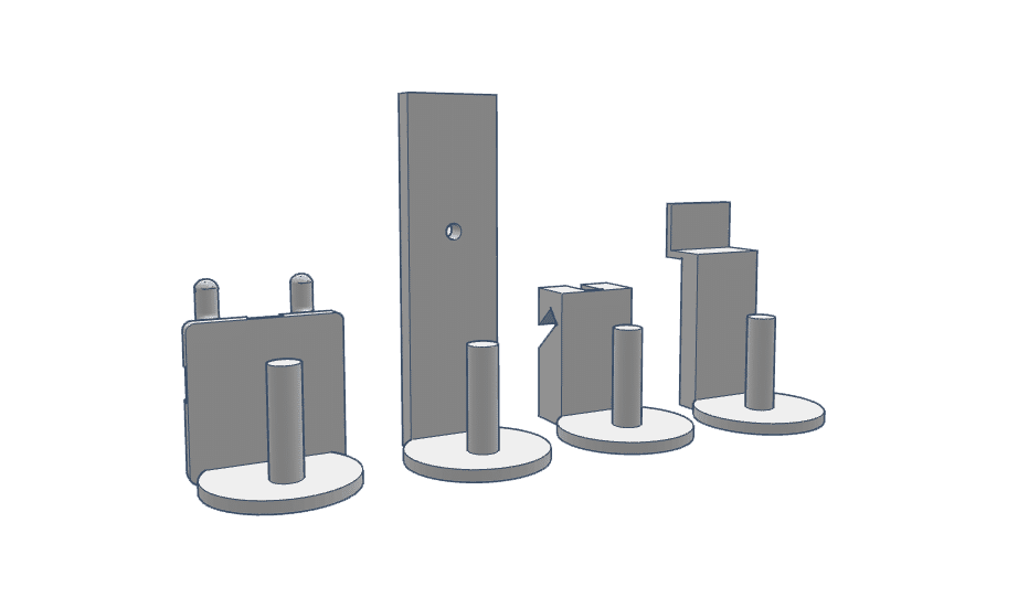 Four distinct firearm accessory components displayed in a row, each with a circular base.