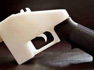 A 3D printed firearm frame with a black grip and a white body.